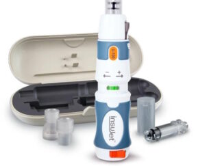 An insulin injector tool. It has a beige case with foam inserts for the tool and attachments, with the attachments and tool positioned in front of the case.