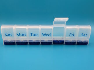 A pill box, with seven compartments labelled for the days of the week. The lid for the Thursday compartment is opened.