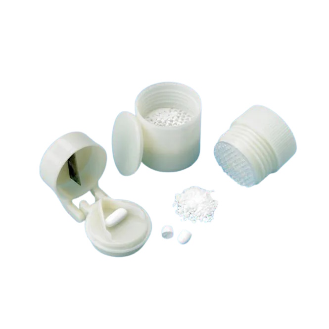 Two white plastic tools are shown. One has a hinged lid with a metal edge inside, to press down on a pill placed in the holder below. The other is a cylinder with a lid that can be removed, and used to crushed pills.
