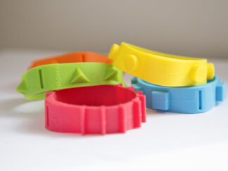 Four different rubber bands with different colours and shapes on the outer rim, such as spikes, square and round dots.