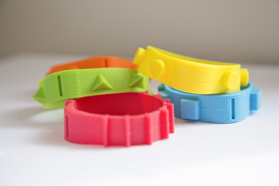 Four different rubber bands with different colours and shapes on the outer rim, such as spikes, square and round dots.