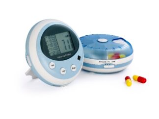 A round pill box with a digital screen and buttons on one side, where alarms can be set. On the other side, pills can be seen in compartments underneath a transparent blue lid.